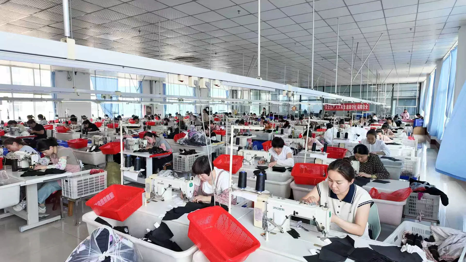Rows of sewing stations across a factory production floor