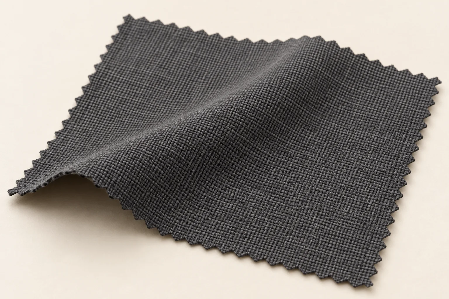 Charcoal woven swatch with a fine interlaced surface and a shallow drape